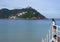 Girl in the bay of La Concha with Santa Clara Island in the background, city of San Sebastian, Euskadi