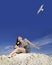 Girl on the beach and flying gull