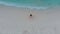 Girl on the beach pulls her hands to the sky and spinning at the surf. Unity with nature.