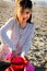 Girl at Beach with Sand Toys