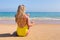 Girl on beach smearing sunscreen on skin