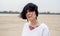 Girl on the beach in a white T-shirt