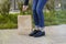 Girl in beautiful shoes leaned over a paper bag.