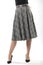 girl with beautiful slender legs in a long wool skirt on a white background, long gray plaid skirt
