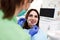 Girl with a beautiful smile at the dentist`s appointment. Dentist examines a patientâ€™s teeth