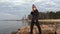 Girl beautifully dances standing on stones near the gulf.