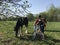 The girl with the bicycle approached the horses grazing in the meadow. Behind the girls backpack, headphones in their ears