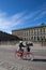 Girl on bicycle passing by the Swedish Royal Palace