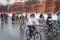 Girl on bicycle rides along of the Kremlin walls in the winter.