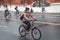 Girl on bicycle rides along of the Kremlin walls in the winter.