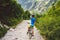 Girl on a Bicycle travels to Slovakia. black helmet, blue shirt, mountains, high Tatras,