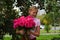 Girl with a big bouquet of pink roses.  Schoolgirl with flowers to teacher