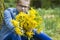 Girl with big bouquet of spring flowers