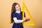 Girl with big ruler. School student study geometry. Sizing and measuring. Kid school uniform hold ruler. School