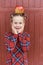 girl with big ruler standing on red wooden background. Farewell Bell. day of knowledge. beginning of the school year