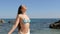 Girl in bikini breathing fresh air on vacation