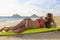 Girl in a bikini lounges on a surfboard