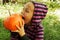 Girl biting pumpkin