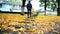 Girl in black clothes and boots walks on footway