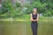 Girl in black dress smiling near by the river