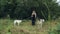 Girl in black dress with two Russian greyhounds