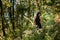 Girl in a black hood dress walking through the woods, enjoying the walk fashion