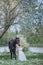 Girl with black horse in blossom garden