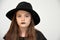 Girl with black men`s hat and black lips