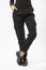 girl in black military trousers and black sports sneakers on