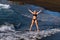 A girl in a black swimsuit jumps on the beach on the island of Tenerife in the Atlantic Ocean, Spain