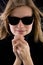 Girl in a black turtleneck with retro sunglasses