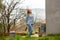 Girl blogger with camera walks in yard of a village house in Provence