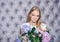 Girl with blond hair, makeup face hold hortensia