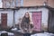 Girl blonde in cat eyes glasses in an artificial faux fur coat in winter