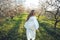 Girl in a blooming garden. A beautiful girl runs in a field with flowers.