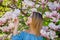 Girl in blossom magnolia garden.