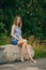 Girl in blouse and skirt having rest at country recreation area, enjoying fresh air and calmness