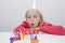 Girl blowing birthday candles at table in house