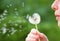 Girl Blowing on Dandelion