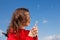 Girl blowing dandelion outdoor