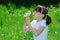 Girl Blowing Dandelion Seeds