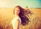 Girl with blowing hair enjoying nature