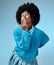 Girl, blue and background with clothes for fashion with hand, face and kiss in studio with afro. Happy, model and