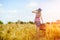 Girl in blue hat walking away in golden sunlight