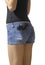 Girl in blue jeans short shorts isolated with pistol in back poc