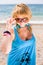 Girl in blue sleeveless dress on seashore