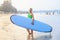 Girl with blue surfboard