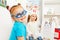 Girl in blue toy glasses at ophthalmologist room