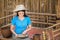 The girl in blue traditional Thai style dress is collecting mushrooms to send orders to customers