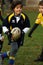 Girl with blue/yellow jacket play rugby